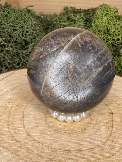 Black Moonstone crystal sphere showing lattice patterning and reflective optical effect