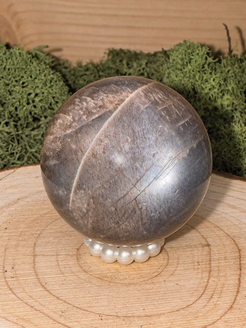 A grade Black Moonstone and lattice Sunstone sphere with silvery asterism, 66g