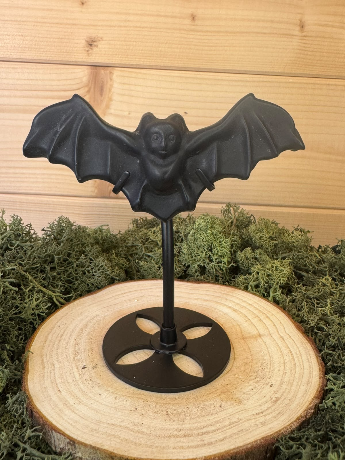Black Obsidian bat carving A with outstretched wings on black display stand