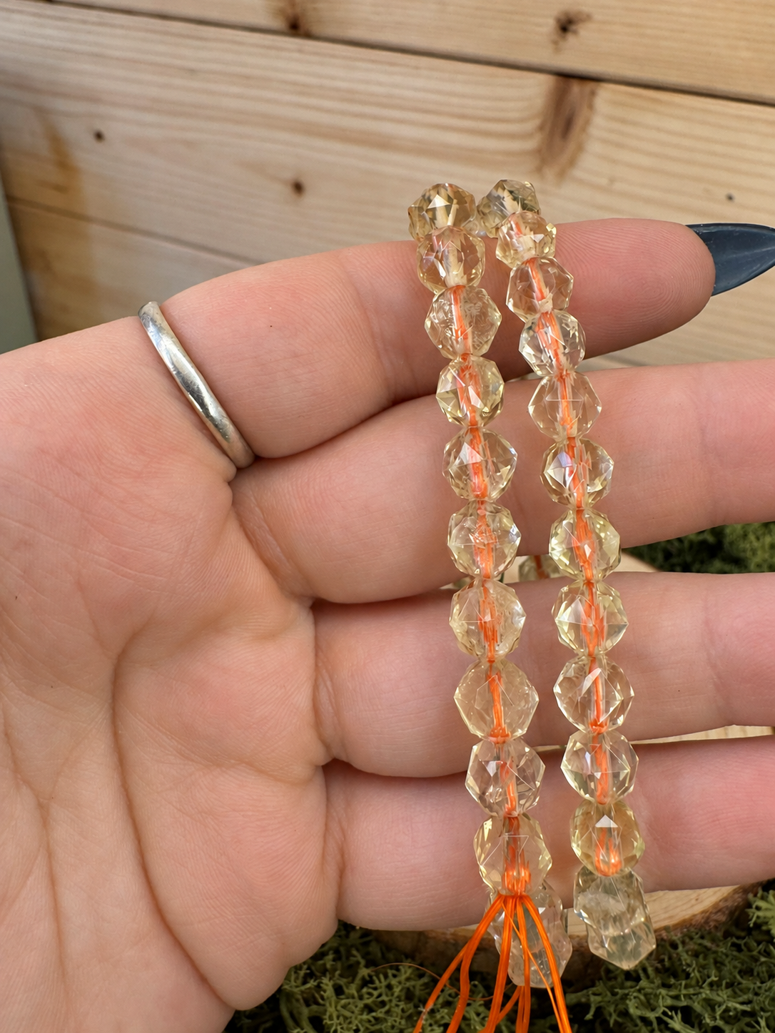 Golden Citrine faceted bead stretch bracelet displayed on natural wood