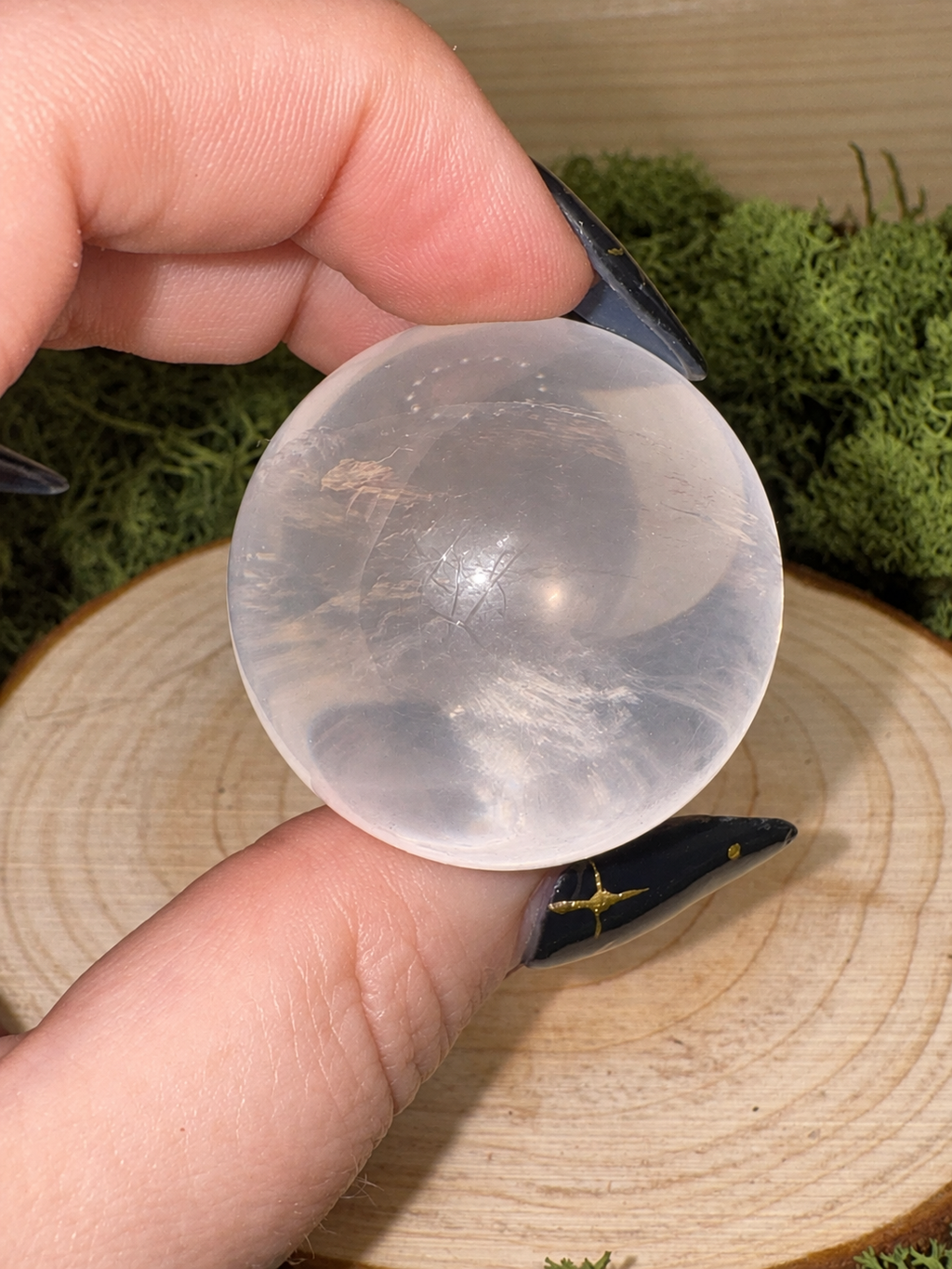 High clarity Ice Rose Quartz sphere showing internal rainbow refraction in direct light