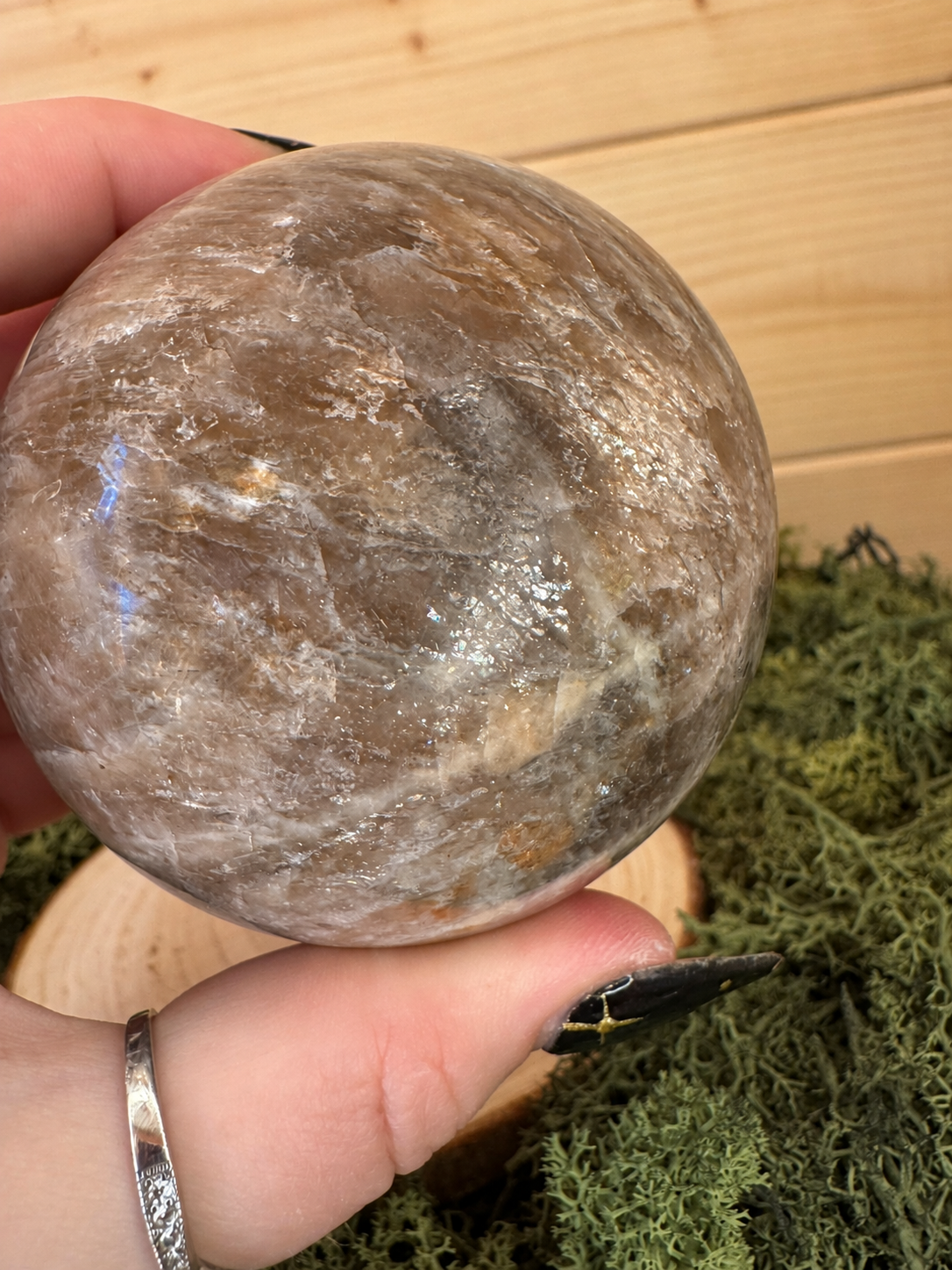 Close up of polished Moonstone and Sunstone sphere with natural feldspar patterning