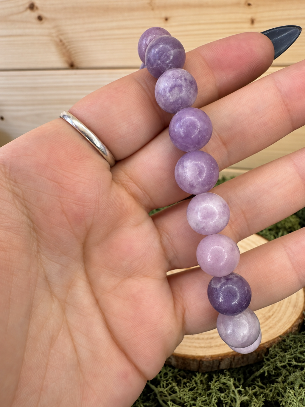 Natural Lepidolite bead bracelet showing varied pale lilac and deep purple colouring