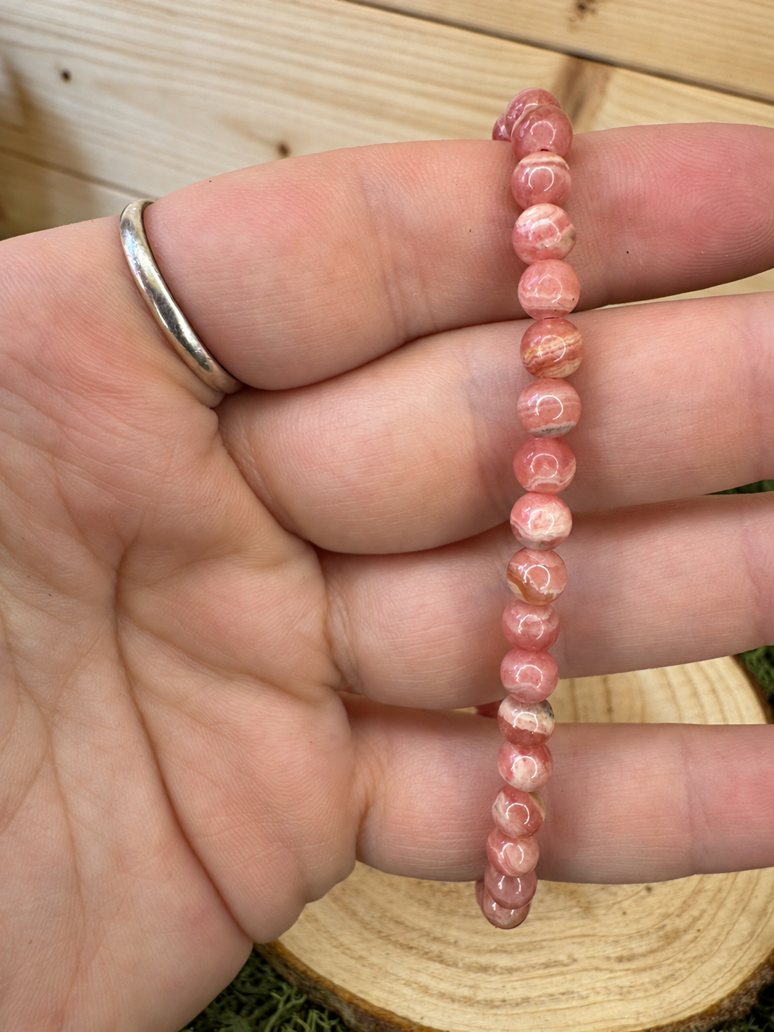 Pink Rhodochrosite bead bracelet showing natural cream and rose banding