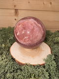 Large pink Strawberry Quartz crystal sphere with natural colour variation and polished finish