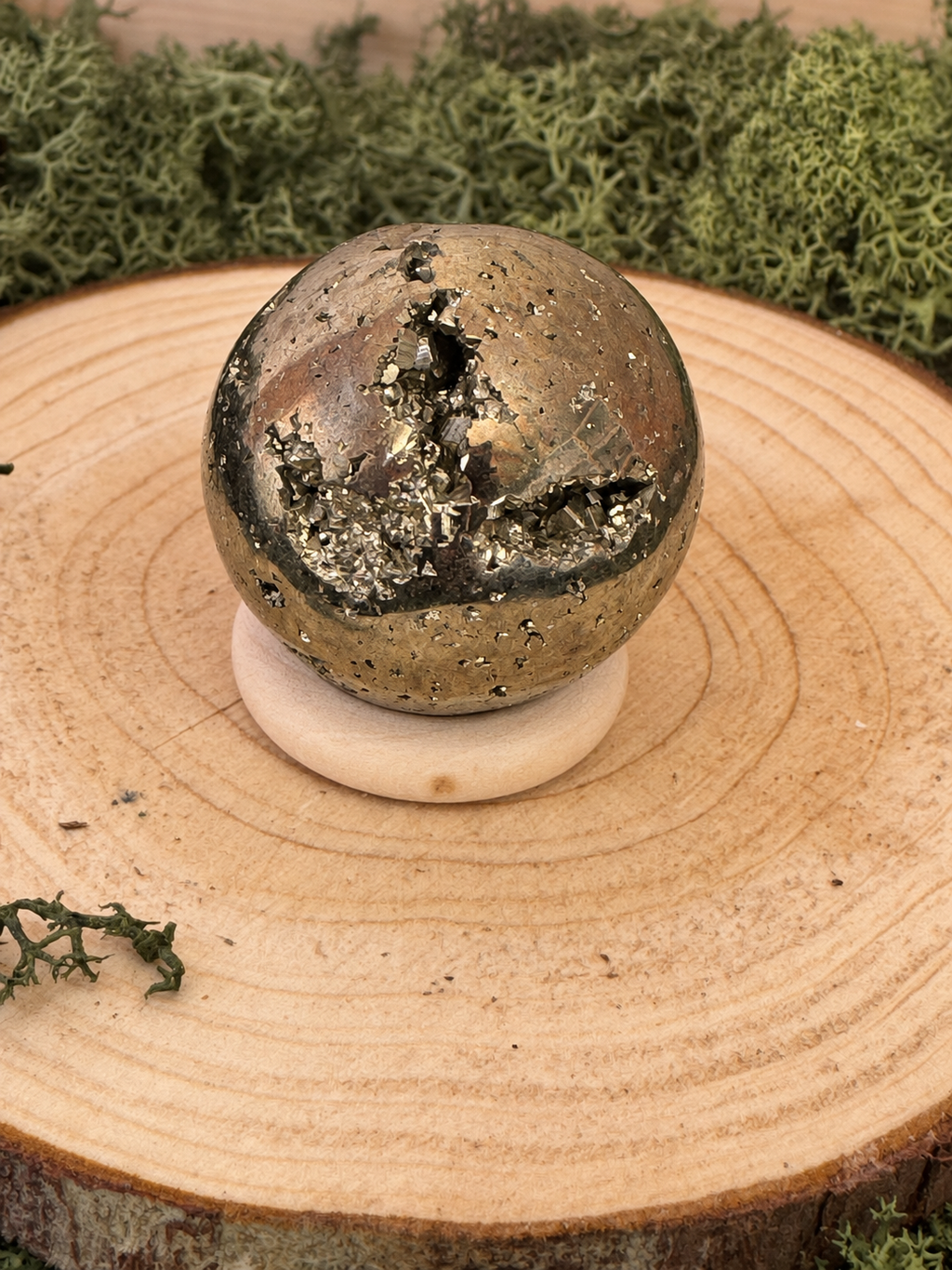 Polished Peruvian Pyrite crystal sphere showing reflective metallic surface