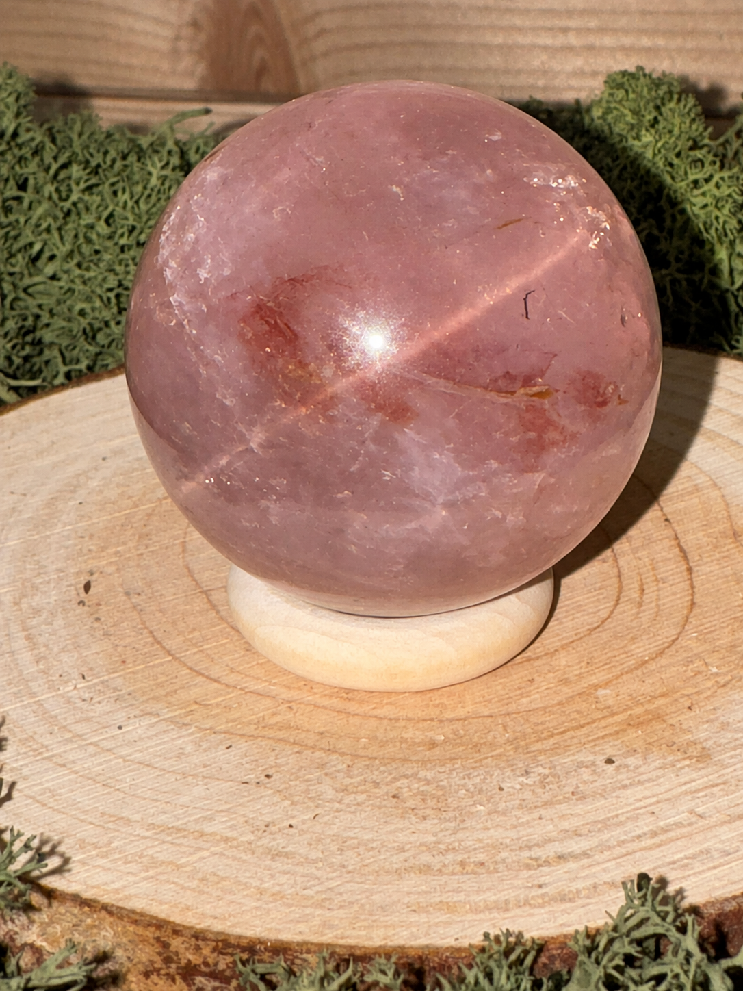 Pink Rose Quartz crystal sphere with red Hematite mineral inclusions