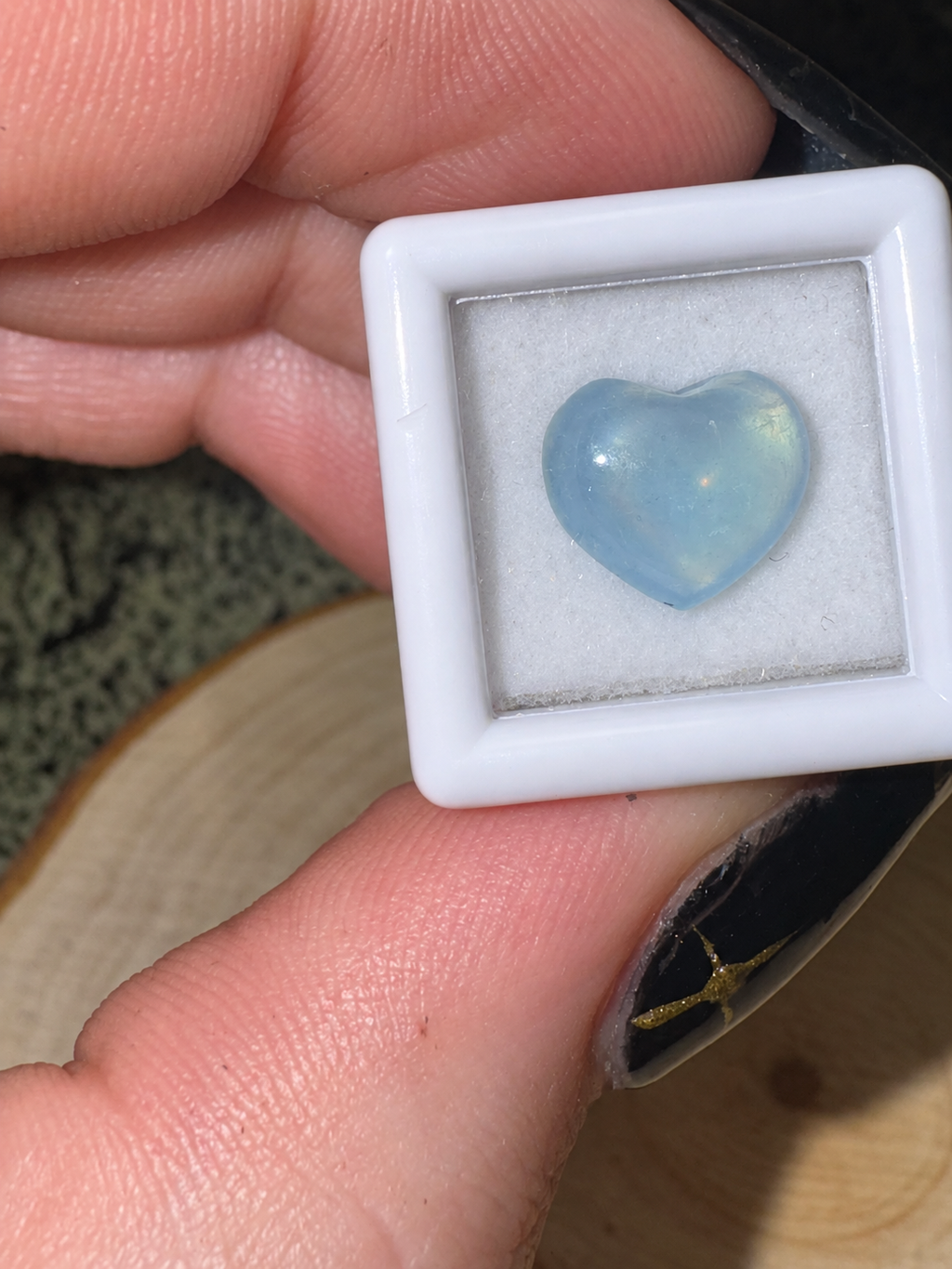 Tiny polished Santa Maria Aquamarine heart showing pale blue colour