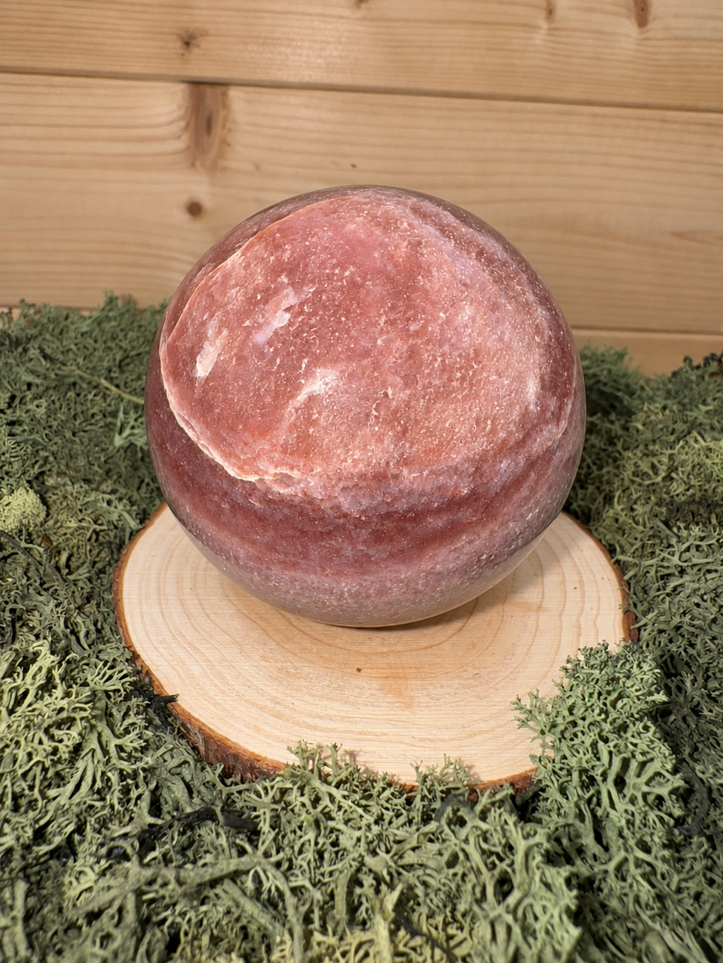 Polished Strawberry Quartz sphere showing natural pink and berry toned banding